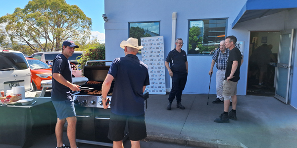 People standing around a BBQ